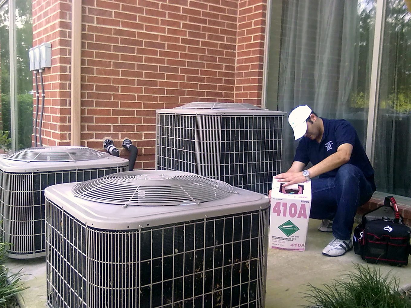 M&S Mechanical technician servicing outdoor AC condensers with R-410A refrigerant